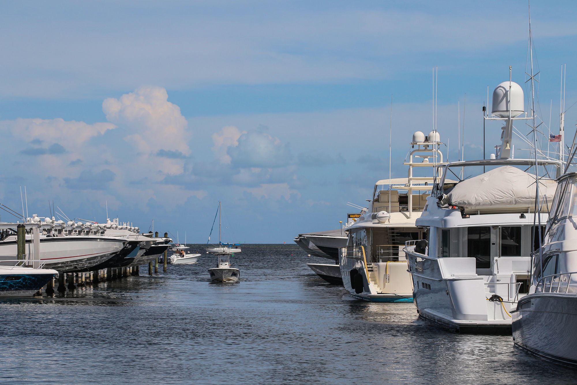 Private timber dock with a moored motor yacht on a calm Intracoastal waterway at sunrise