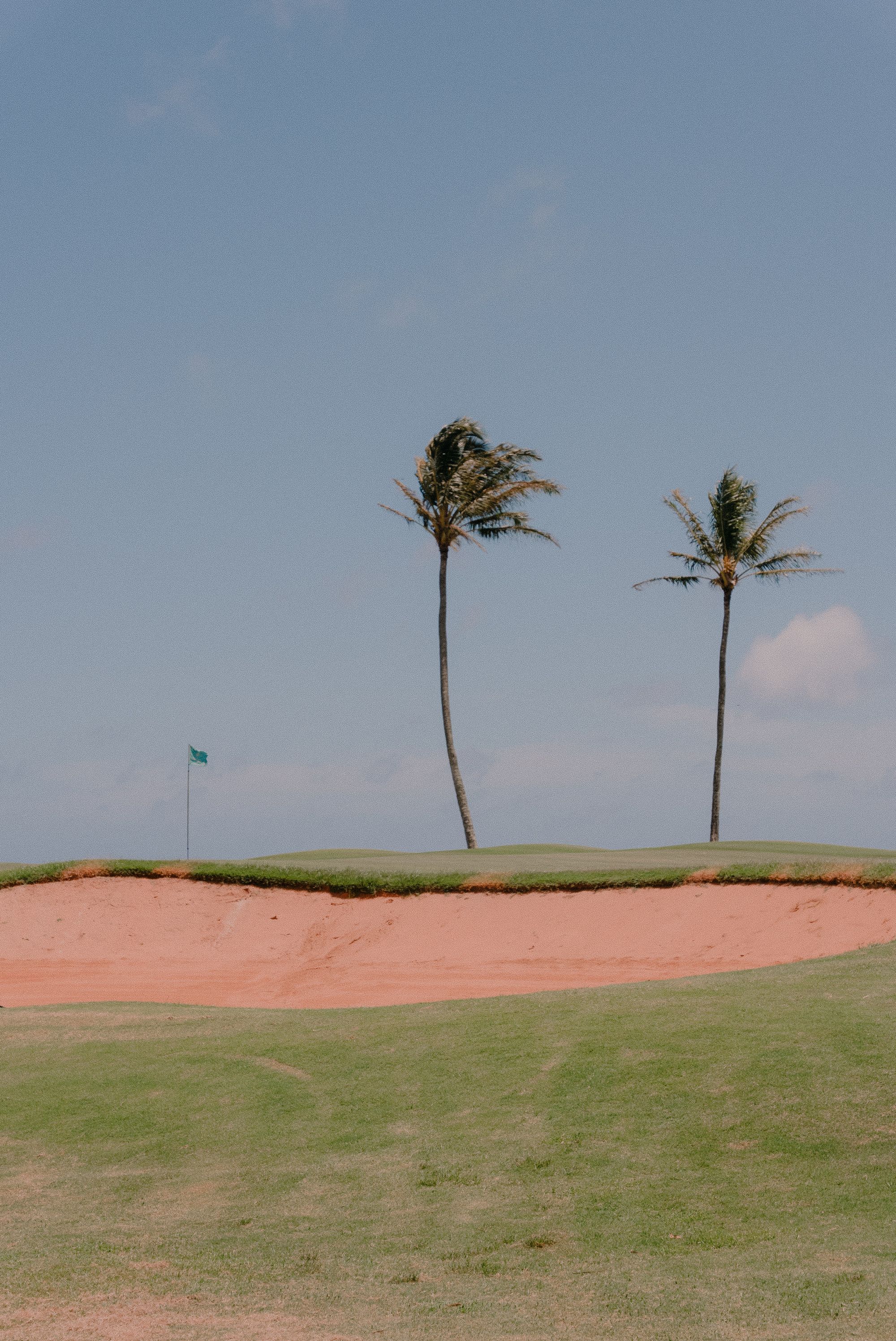 Manicured fairway and limestone clubhouse at sunrise in a Palm Beach Gardens golf community
